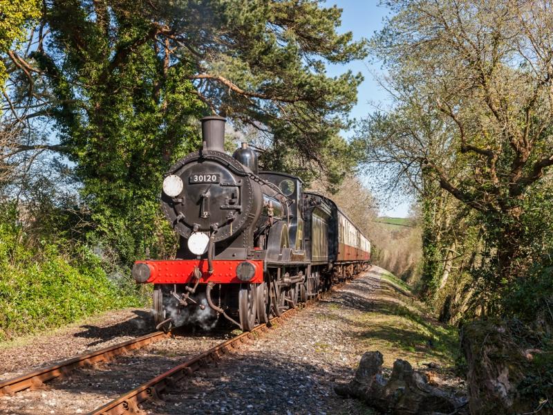Steam train travelling along the Bodmin and Wenford Heritage Railway