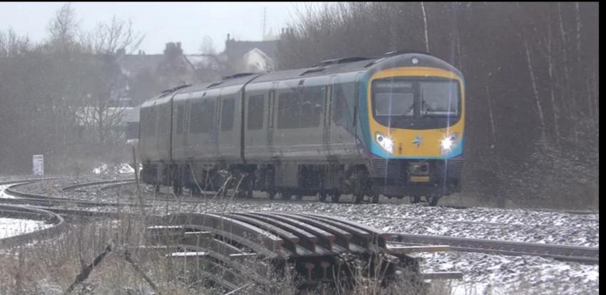 TransPennine Express Train travelling across lightly dusted snowy tracks