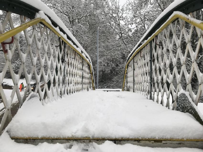 Close up of path on top of footbridge covered in snow