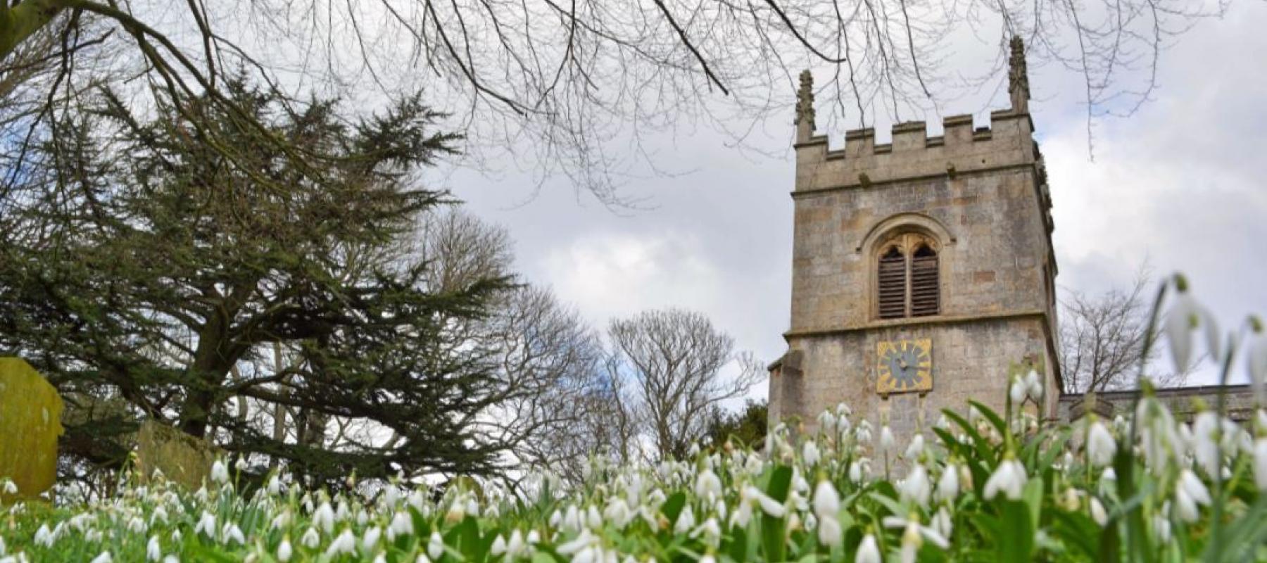 Traditional English church with snowdrops