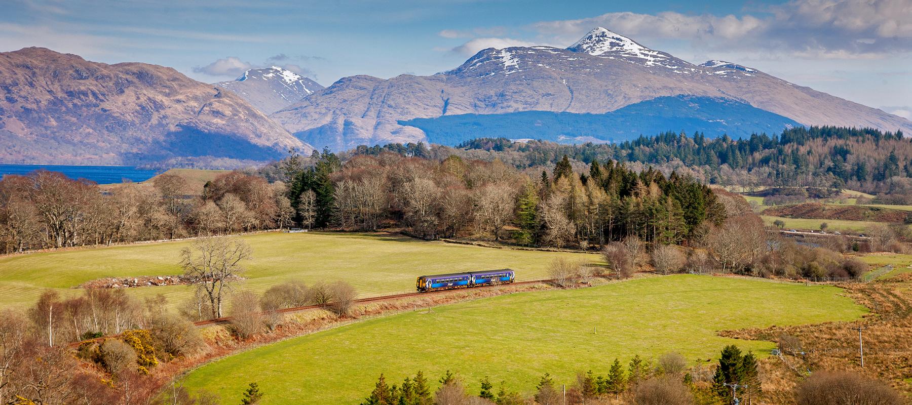 Train on the West Highland Line with mountains in the background