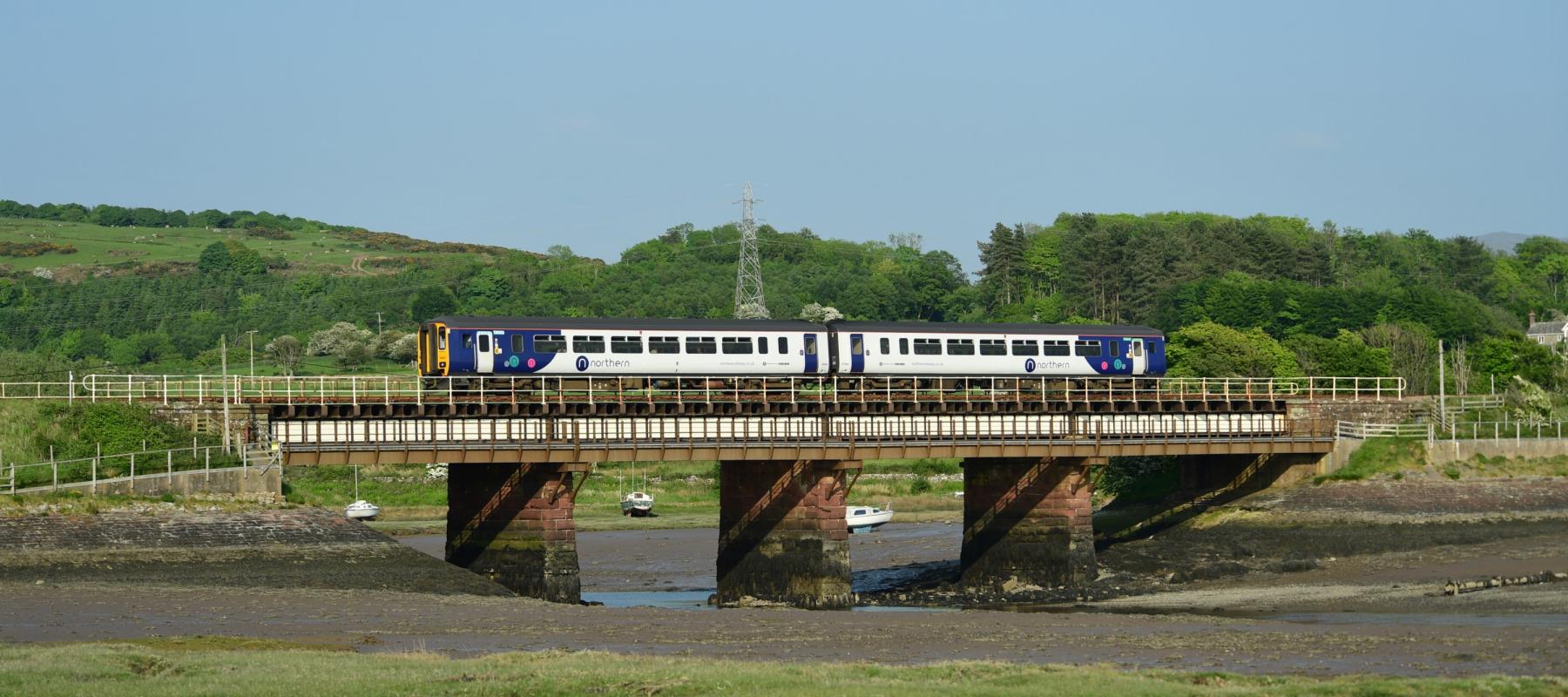 Northern train travelling along the Cumbrian Coast at Ravenglass