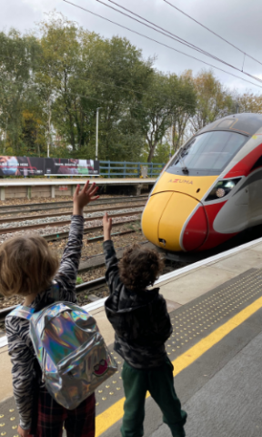 Family waving at train on a day out