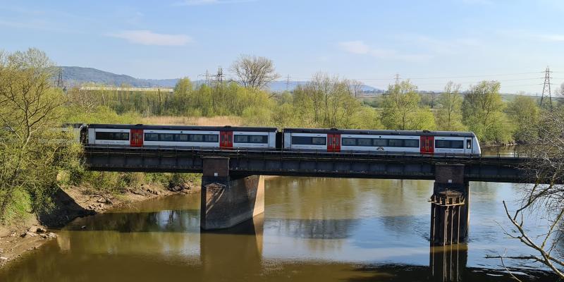 Seven Shores Line, train crossing a river in the sunshine