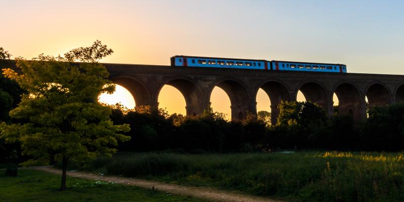 Evening train travelling across the Chappel Viaduct along the Gainsborough Line. East UK