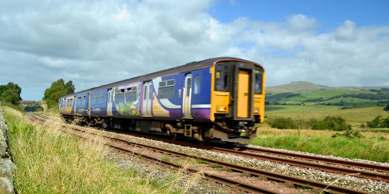 Train passing Ingleborough, near Clapham along the Bentham Line. Yorkshire & North East UK